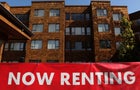 Apartment complex with "now renting" sign 
