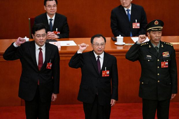 State councilor Li Shangfu (right) swears an oath after he was elected during the fifth plenary session of the National People's Congress (NPC) at the Great Hall of the People in Beijing on March 12, 2023. 