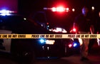 Two police officers behind crime scene tape 