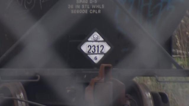 A placard on a freight train with the number "2312" underneath an image of a skull and crossbones. 