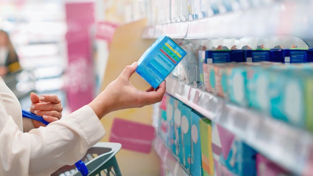 Woman choosing products in drugstore 