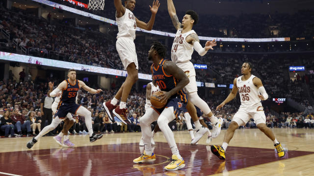 Julius Randle #30 of the New York Knicks attempts to shoot while being defended by Evan Mobley #4 of the Cleveland Cavaliers and Danny Green #14 during the first quarter of Game Five of the Eastern Conference First Round Playoffs at Rocket Mortgage Fieldh 