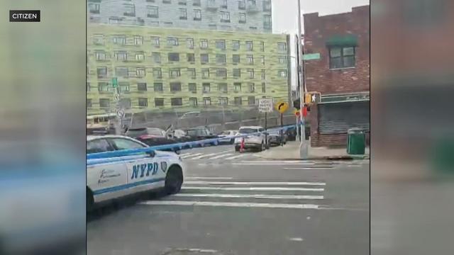 An NYPD vehicle and crime scene tape block off a street. 