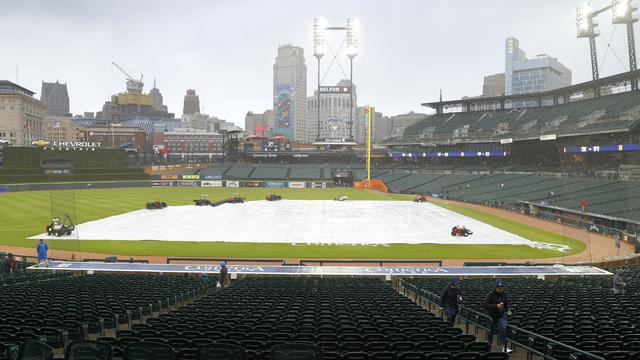 Fans walk around Comerica Park while waiting out a rain delay as the tarp covers the field ahead of a game between the Detroit Tigers and New York Mets on May 2, 2023 in Detroit, Michigan. 