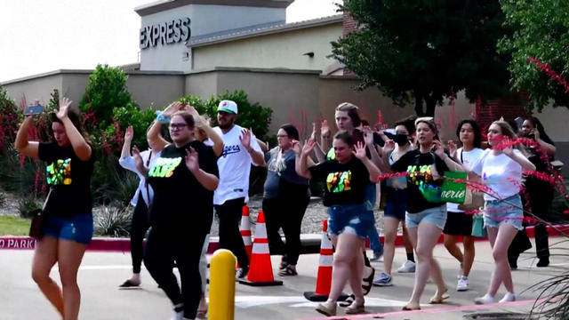 Shoppers leave with their hands up after police responded to a gunman who shot and killed eight people and wounded at least seven others at Allen Premium Outlets mall north of Dallas, in Allen, Texas, U.S. May 6, 2023. 