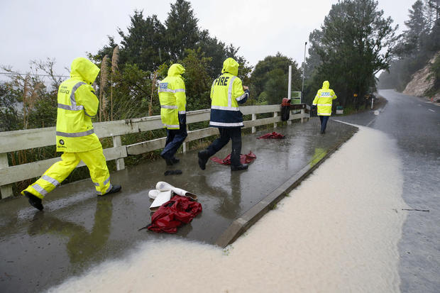 Police and rescuers wait at a roadblock during the search for a student who went missing on a school trip to New Zealand's Abbey Caves in Whangarei, May 9, 2023. 