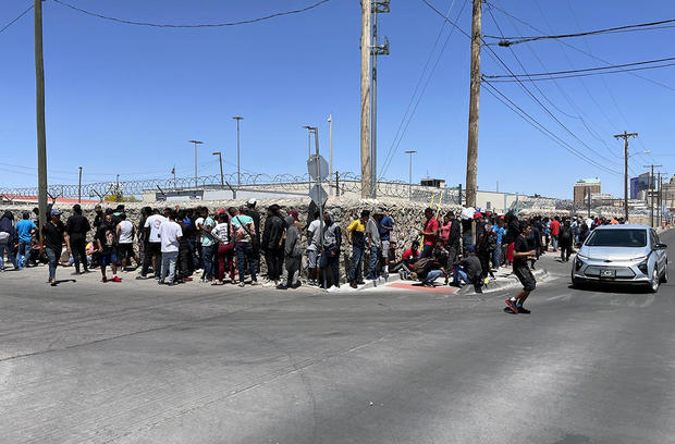 Migrants line up at the Paso del Norte port of entry to be processed by Border Patrol agents in Texas. 