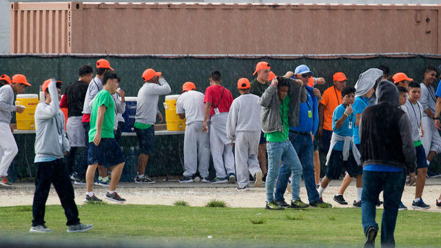 Young people stop to get something to drink on the grounds of the Homestead Temporary Shelter for Unaccompanied Children as members of Congress visit the facility during an oversight tour on July 15, 2019, in Homestead, Florida. 