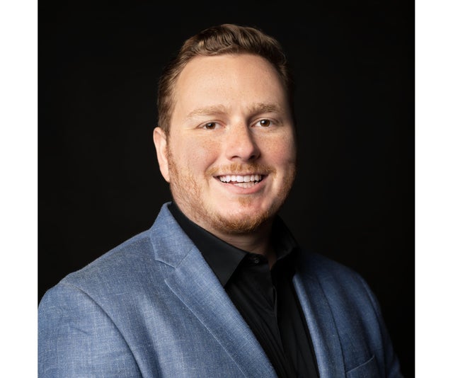 Headshot of Victor Schwartz in a blue-gray suit. 