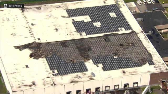 An aerial view of fire damage to the roof of a South Brunswick warehouse. 