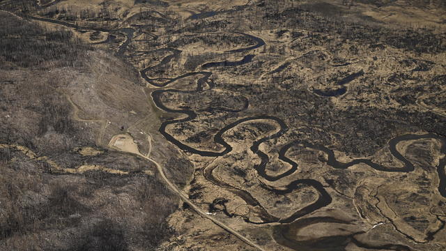A twisted Colorado River snakes across Kawuneeche Valley scarred by a fire near the headwaters of the Colorado River on May 13, 2023, in Rocky Mountain National Park, Colorado. 