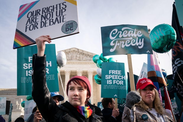 Members of both sides of the debate stand in front of the Supreme Court on Monday, Dec. 5, 2022, in Washington, D.C.