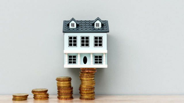 House Model on Top of Stack of Coins 