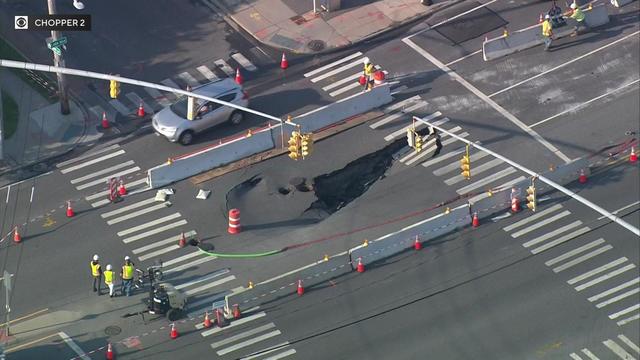 An aerial view of a large sinkhole in the middle of an intersection in Lido Beach. 