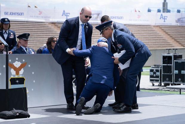 President Biden is helped up after falling during the graduation ceremony at the United States Air Force Academy, just north of Colorado Springs in El Paso County, Colorado, on June 1, 2023. 