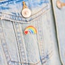 Close-up of a heart rainbow badge on denim jacket pocket 