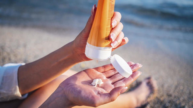 Woman using sunscreen 