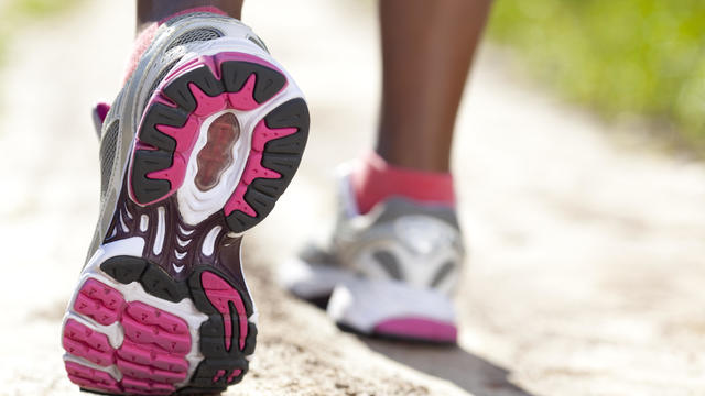 Close up of women's running shoes on outdoor trail 