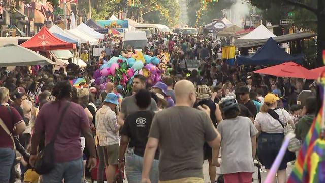People and vendors pack a Brooklyn street. 