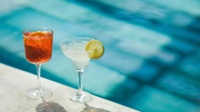 Two cold fresh summer cocktails on poolside close-up. Spritz and Margarita 