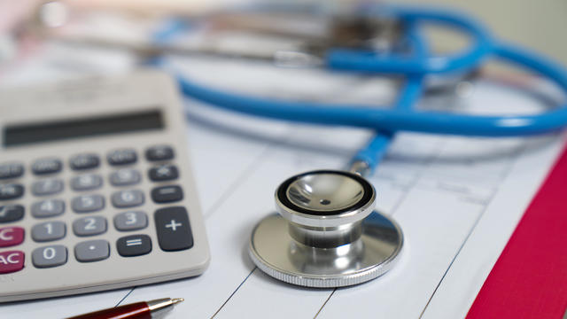 Cost of health care concept, stethoscope and calculator 