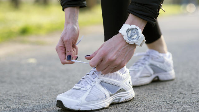 Woman tying her shoes before a jog 