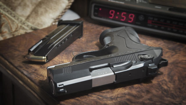 Semi-automatic pistol on bedside nighstand 