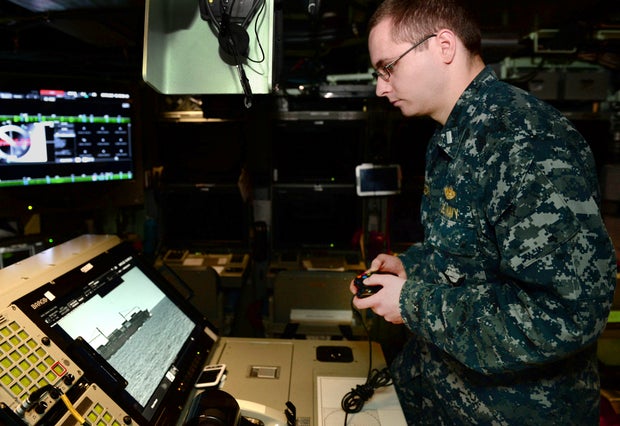 In this Feb. 2, 2018 photo released by the U.S. Navy, Lt. j.g. William Gregory uses an Xbox game controller to maneuver the photonics mast aboard the submarine scheduled to be commissioned as the USS Colorado on Saturday, March 17, 2018, in Groton, Conn