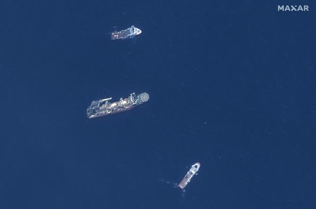 In this satellite image provided by Maxar Technologies, from top to bottom, the vessels Horizon Arctic, Deep Energy and Skandi Vinland search for the missing submersible Titan, Thursday, June 22, 2023, in the Atlantic Ocean. 