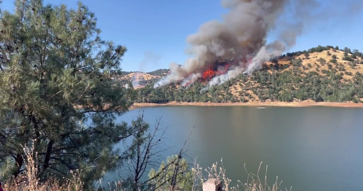 Firefighters battle vegetation blaze near Jamestown, Don Pedro Lake