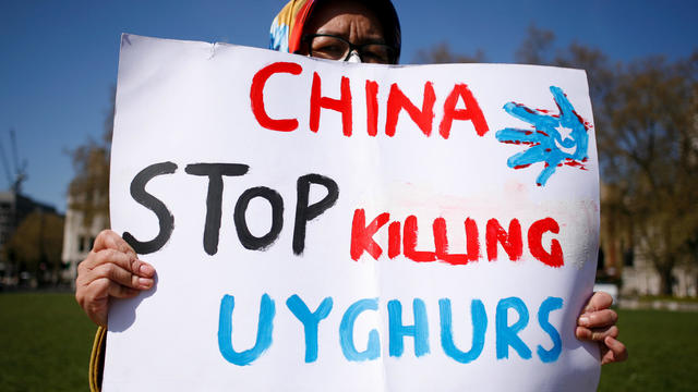 Members of the Uyghur community demonstrate outside the London's Houses of Parliament 