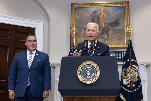 President Biden speaks alongside Education Secretary Miguel Cardona in the Roosevelt Room of the White House on Friday, June 30, 2023. 