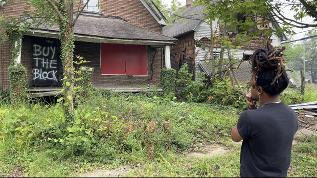 Tray Little in front of the property he bought as part of his "Buy the Block" campaign. 