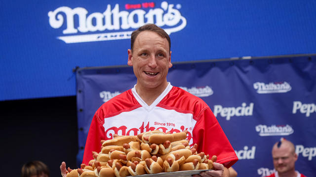 Joey Chestnut holds a tray of hot dogs during the weigh-in ceremony ahead of the Nathan's Famous Fourth of July International Hot Dog Eating Contest in New York City, July 3, 2023. 