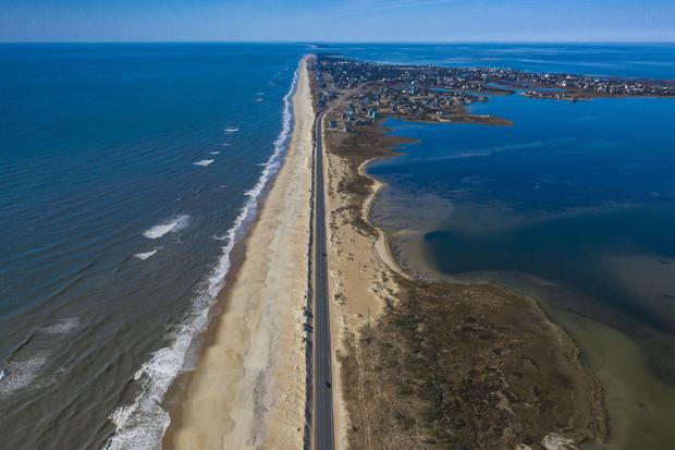 Drone aerial view of Outer Banks Highway 12 with Atlantic Ocean and Sound on both sides, Cape Hatteras National Seashore 