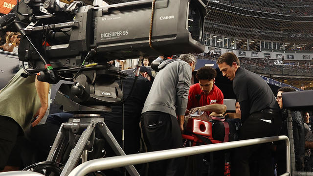 A camera man is carted off the field after getting hit by an errant throw in the fifth inning during the game between the New York Yankees and the Baltimore Orioles at Yankee Stadium on July 5, 2023 in Bronx borough of New York City. 