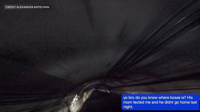 A text message reading "yo bro do you know where kosse is? His mom texted me and he didnt go home last night." is overlaid over video taken from the top of a subway car going through a tunnel. 