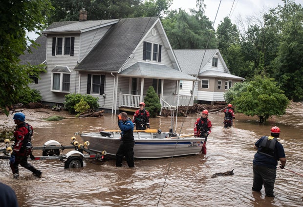 Emergency personnel with e a boat that was used to rescue residents in Stony Point, Ne wYork