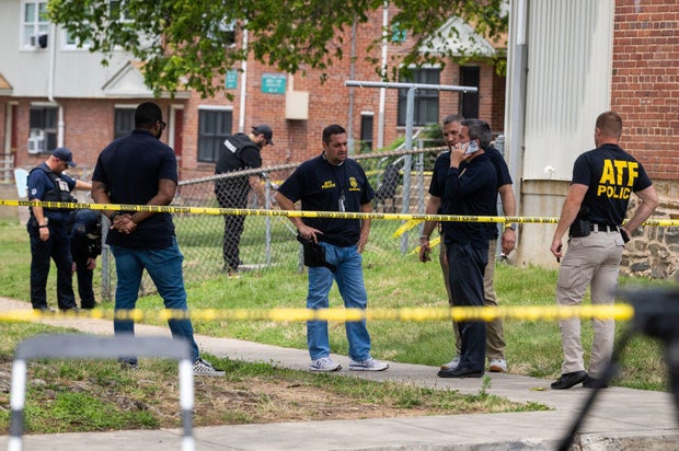 Authorities search for evidence at the scene of last nights mass shooting that left 2 dead and 20 wounded, on July 02 in Baltimore, MD.