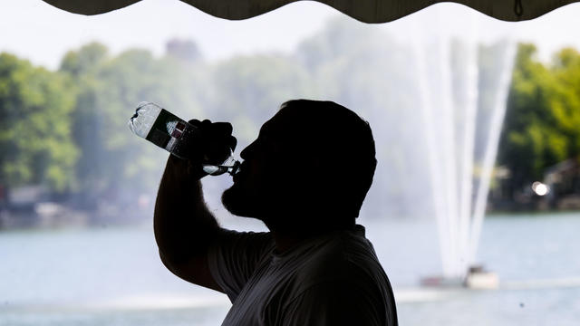 Man drinks from water bottle 