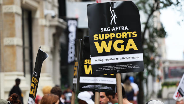 Members of the Writers Guild of America East are joined by SAG-AFTRA members as they picket at the Warner Bros. Discovery NYC office on July 13, 2023 in New York City. 