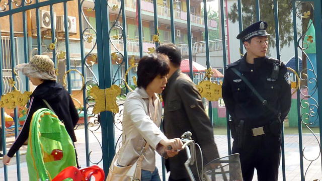 A Chinese policeman monitors the situati 