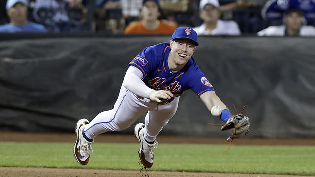 Brett Baty #22 of the New York Mets can't come up with a pop up at third base hit by Max Muncy (not in the picture) of the Los Angeles Dodgers in the ninth inning at Citi Field on July 15, 2023 in New York City. 
