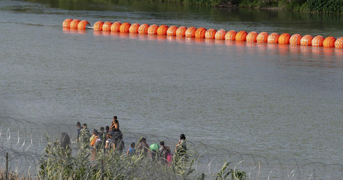 Justice Department threatens to sue Texas over floating border barriers in Rio Grande