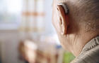 Ear of senior man with hearing aid 