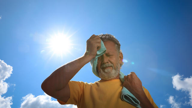 Man outdoors under the sun in the heat 