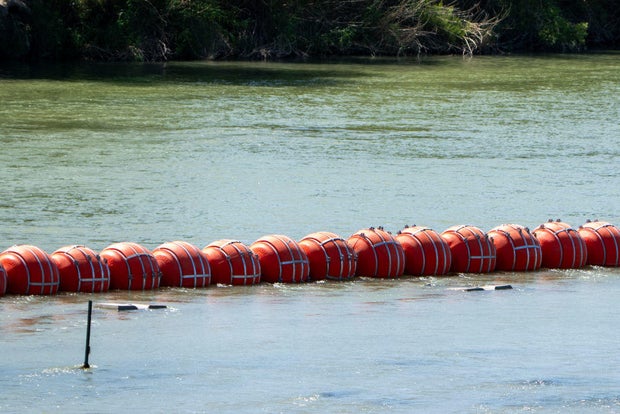 Buoys are placed on the water along the Rio Grande border with Mexico in Eagle Pass, Texas, on July 15, 2023, to prevent migrants from entering the U.S.