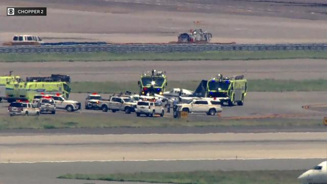 Emergency vehicles surround a small plane on the tarmac at John F. Kennedy International Airport. 