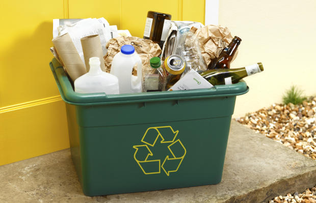 Items for recycling in a bin with the "chasing arrows" symbol 