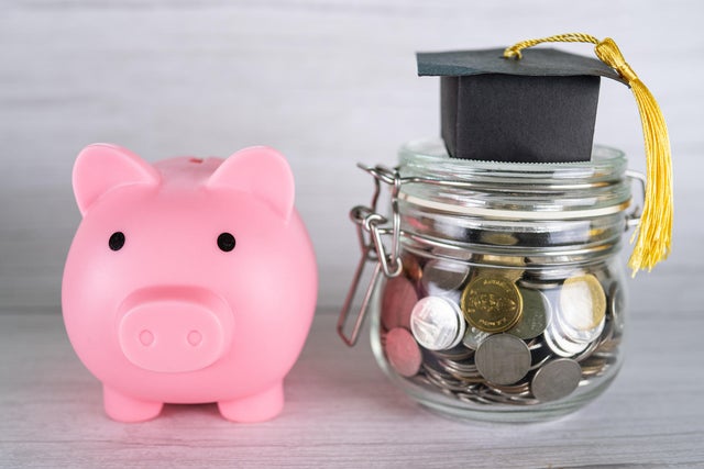 Close-up of coins in jar with piggy bank on table,Romania 